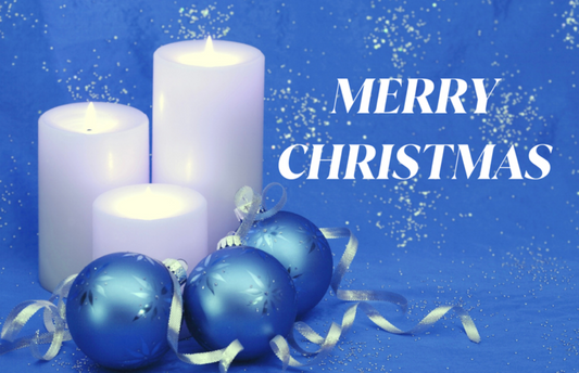 Merry Christmas With Three Lit White Candles, Three Blue Ornaments And A Ribbon